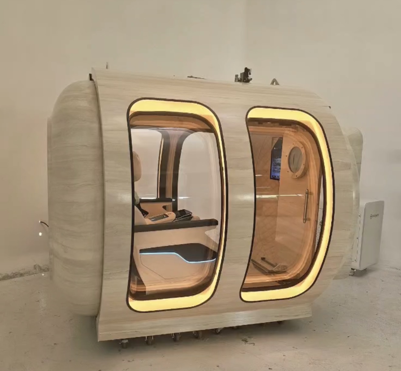 Stone-finished twin-door hyperbaric chamber with warm interior lighting