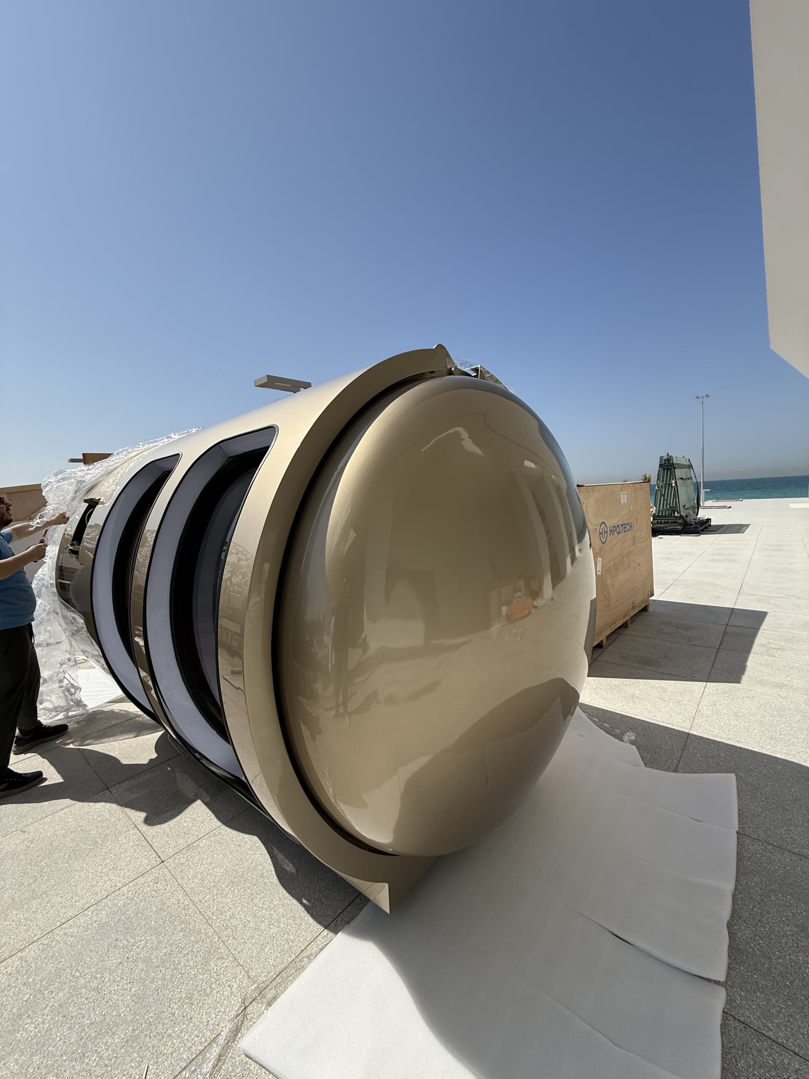 Champagne-finished hyperbaric chamber arriving at the residence