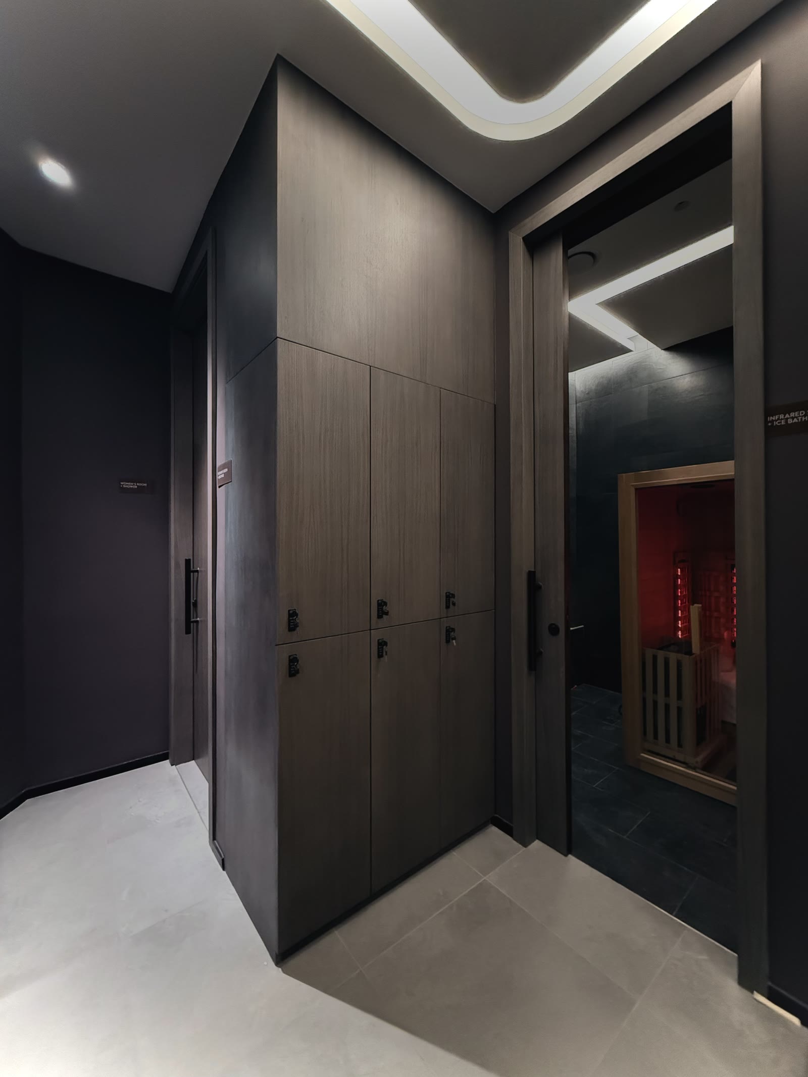 Infrared sauna set into the dark timber recovery corridor