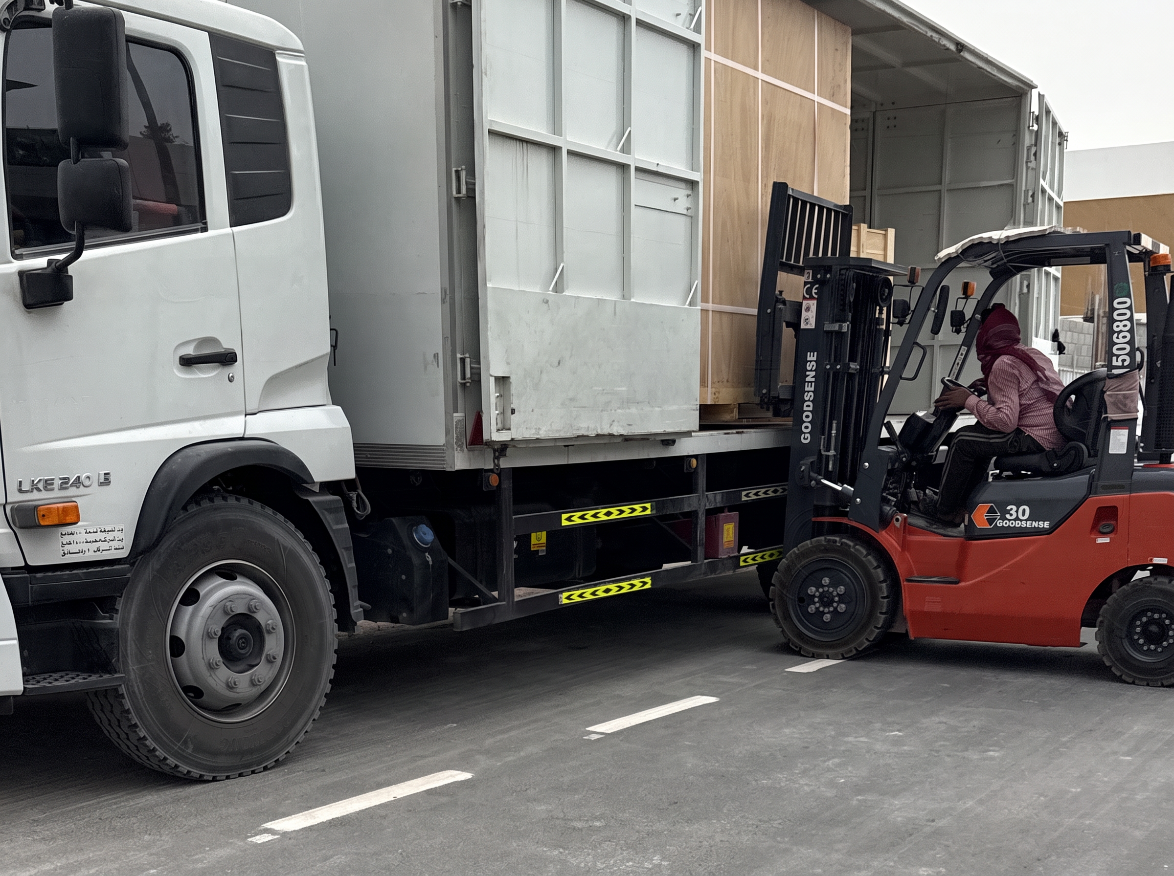 Crated equipment offloaded by forklift on delivery day at the villa