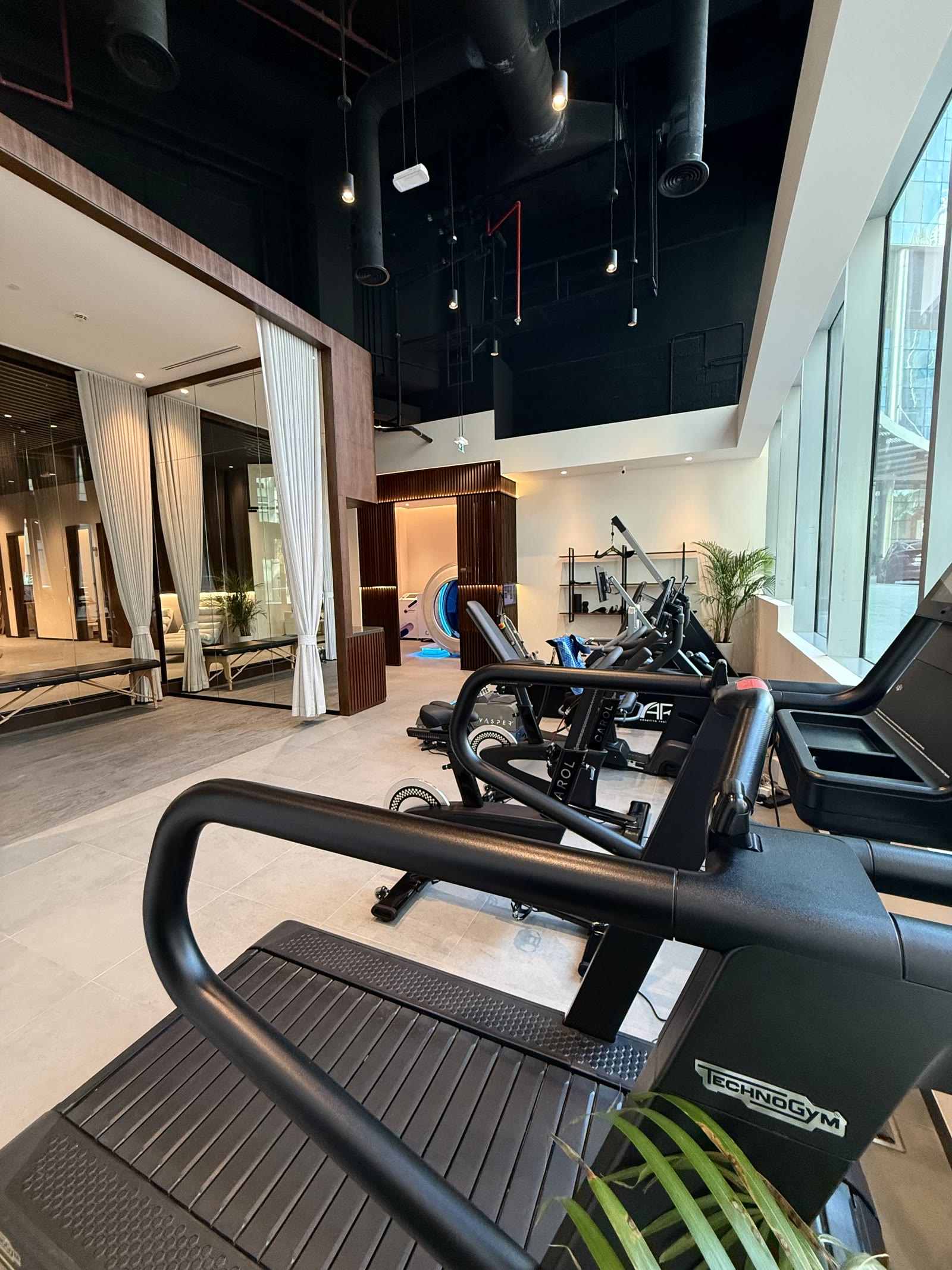 Double-height training floor with cardio and strength equipment