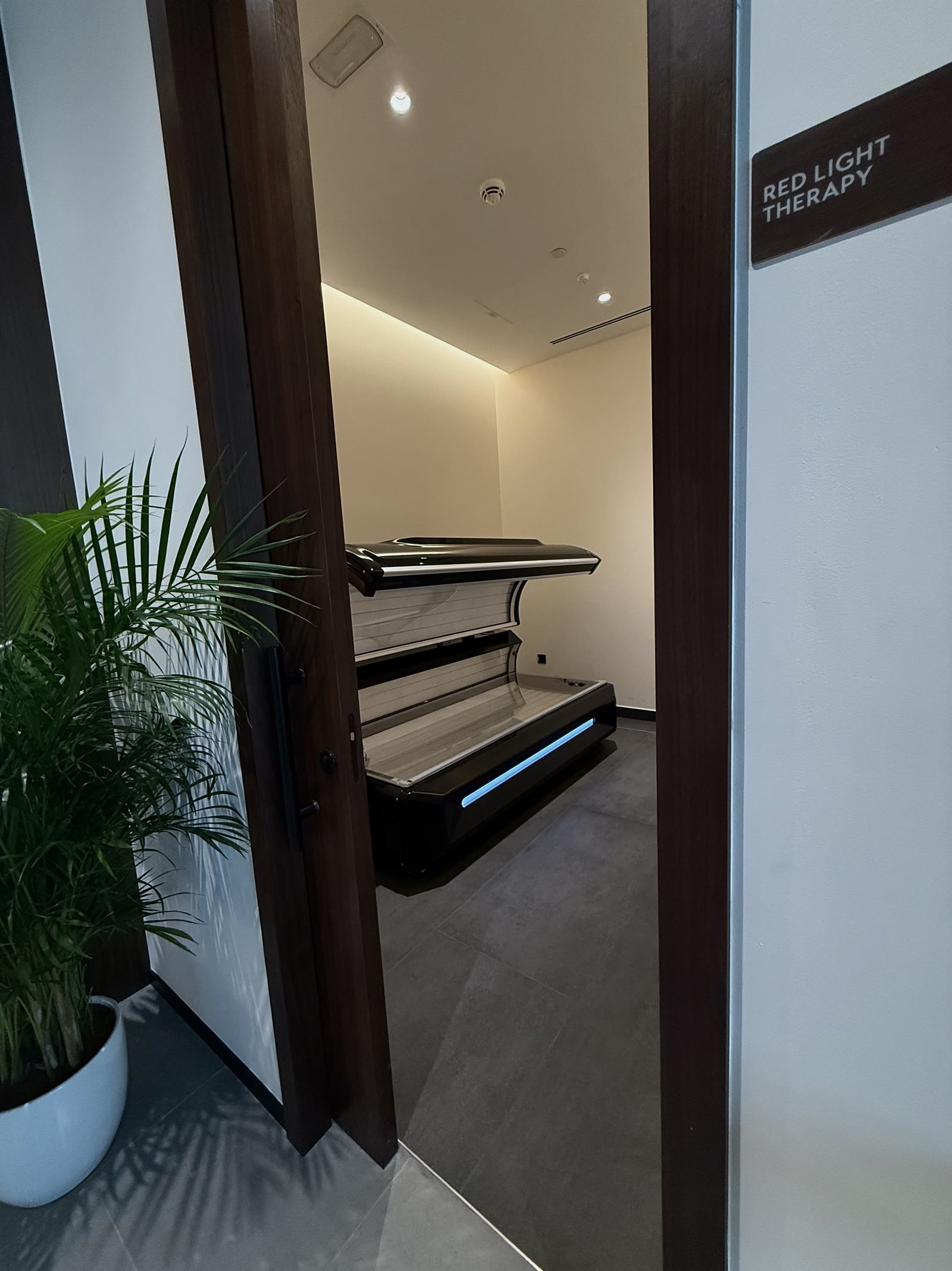 Red light therapy bed at the entrance to the therapy suite